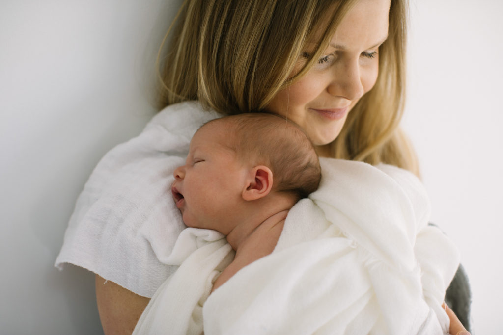 Photo of mother holding newborn baby at Homer Glen studio  Maternity and newborn photographer Elle Baker Photography
