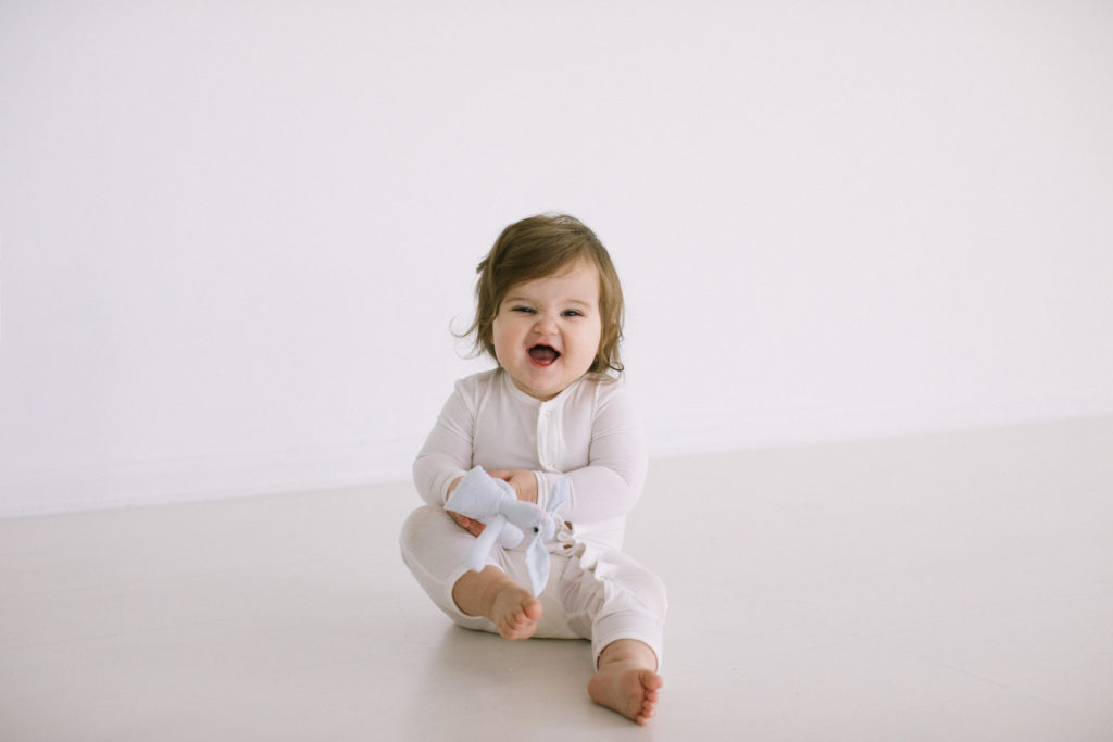 Cute giggling baby laughing milestone session. Best lifestyle baby photographer Chicago