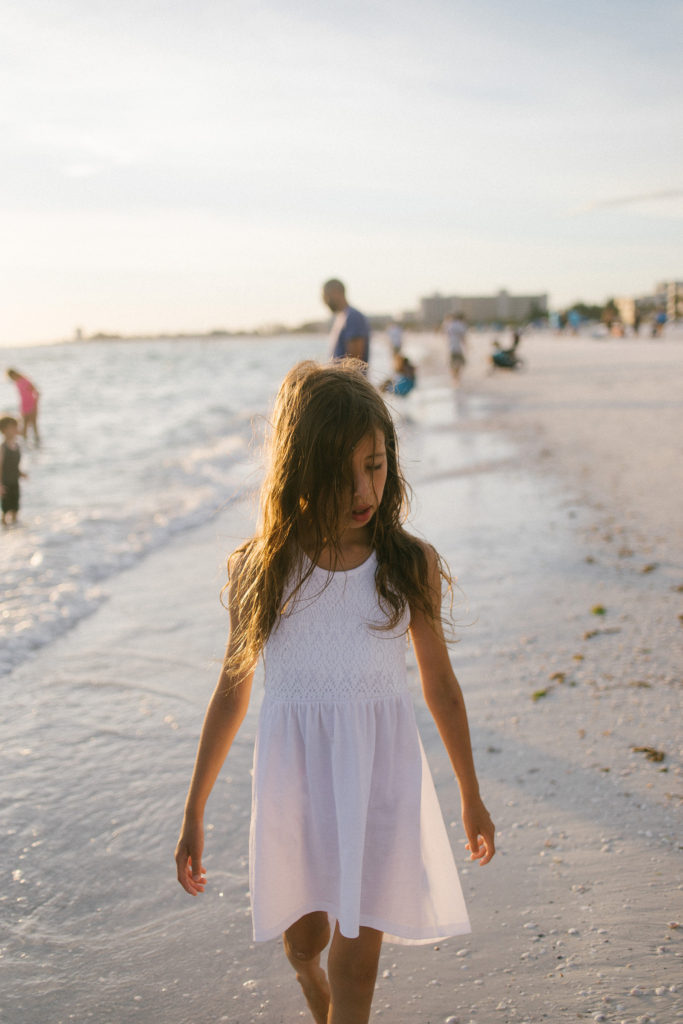 Laurie Baker captures young girl in white dress on beach