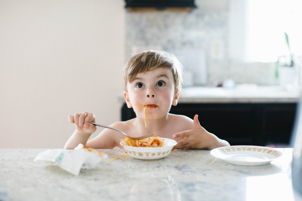 The art of the everyday lifestyle photography boy eating messy spaghetti dinner
