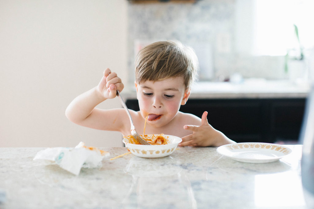 The art of the everyday lifestyle photography boy eating messy spaghetti 