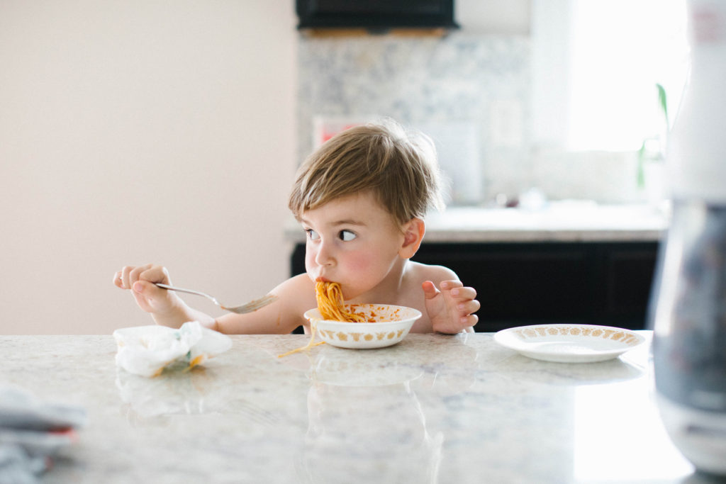 The art of the everyday lifestyle photography child eating spaghetti dinner