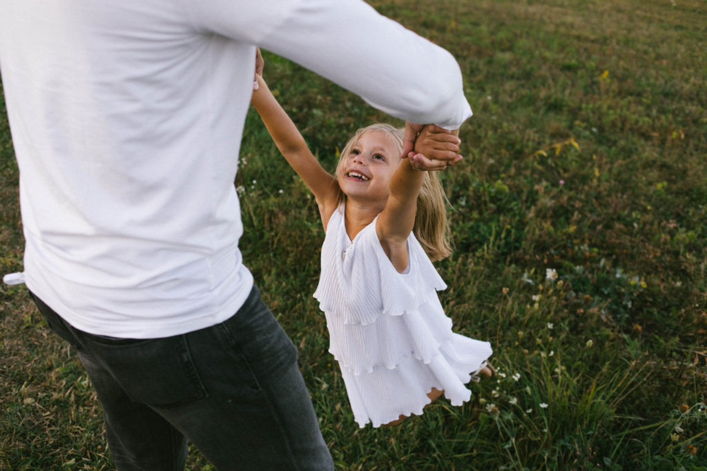 let's go fly a kite | Elle Baker Photography | Little girl being swung around smiling
