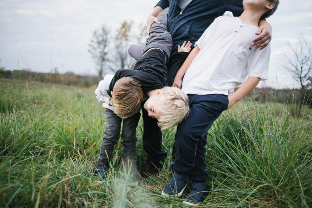 Large family sessions with Elle Baker Photography near Chicago. A group of young boy playing with playing wearing Zara clothing