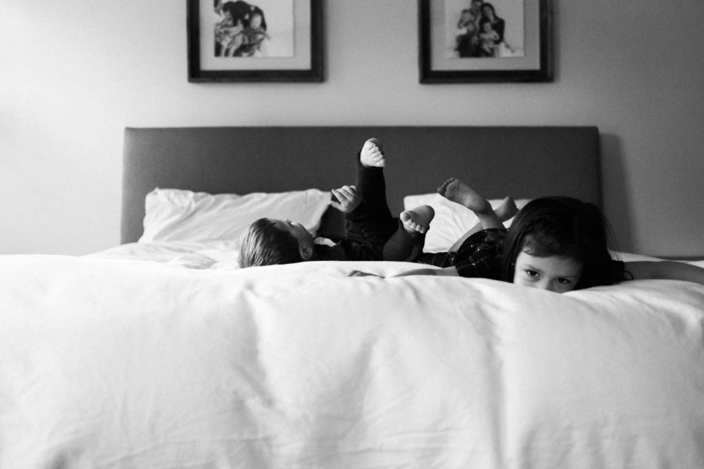 Family time in Lisle IL | Chicago family and lifestyle photographer captures  kids jumping on bed