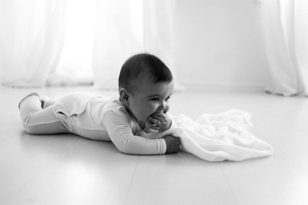 Chicago photographer captured Six Month Milestone Sessions including a gorgeous baby photographed on his tummy in a white studio