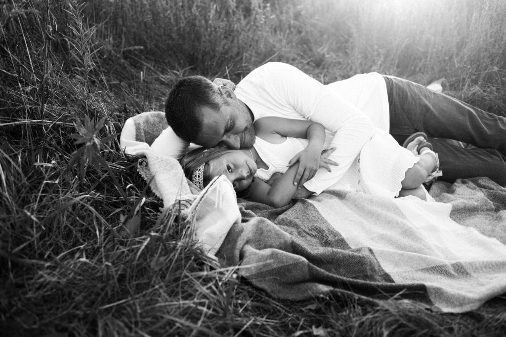 let's go fly a kite | Elle Baker Photography | father and daughter snuggling on blanket during session