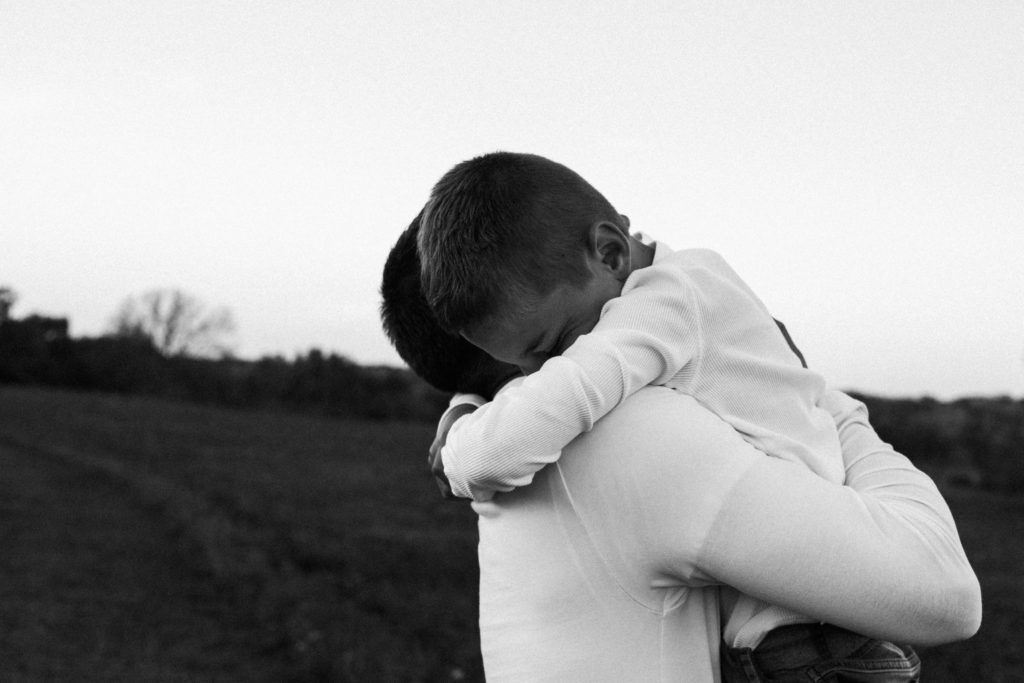 let's go fly a kite | Elle Baker Photography | Father and son embrace black and white