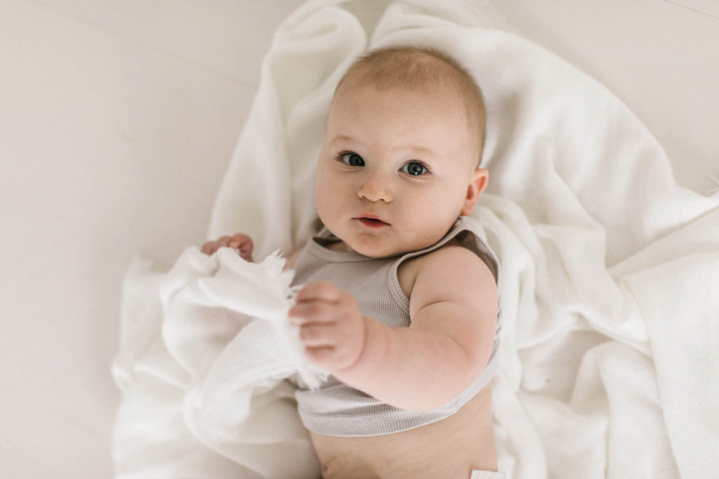 Detail shots during a baby session, Elle Baker Photography, La Grange Illinois baby photographer, baby boy holding white blanket in white studio