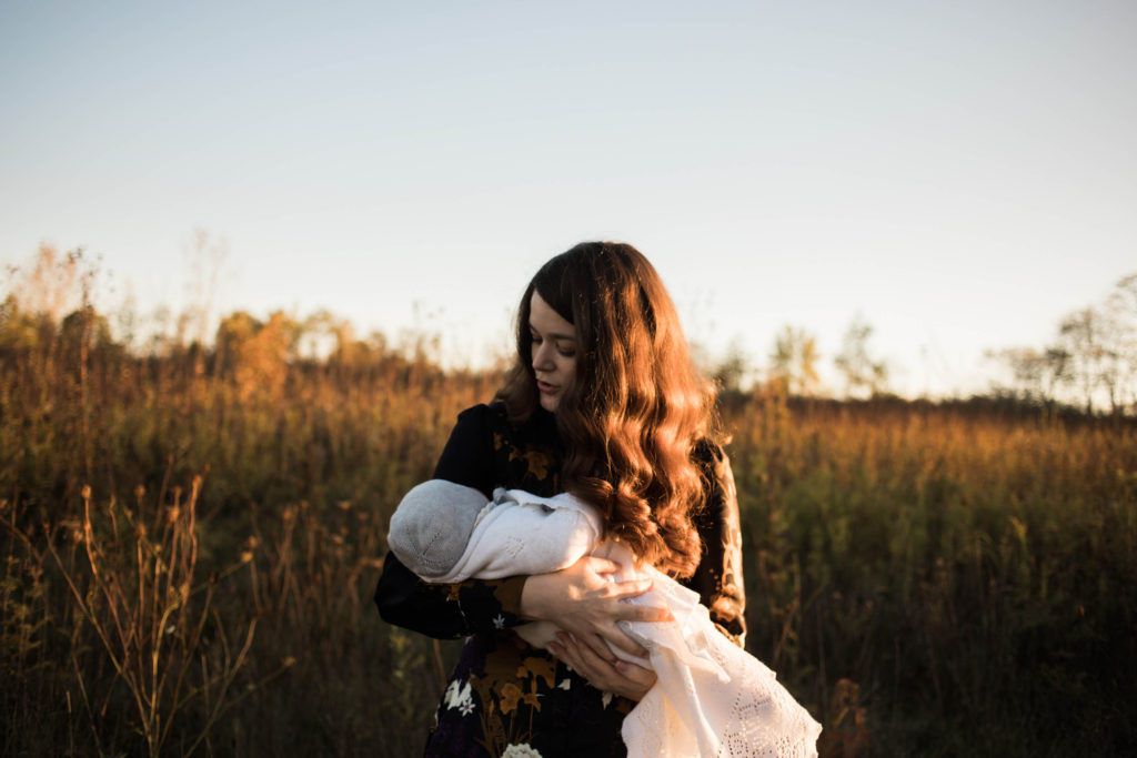 Naperville Illinois Forest Preserve, Photos by Elle Baker Photography, Mom holding newborn girl at sunset during photo shoot