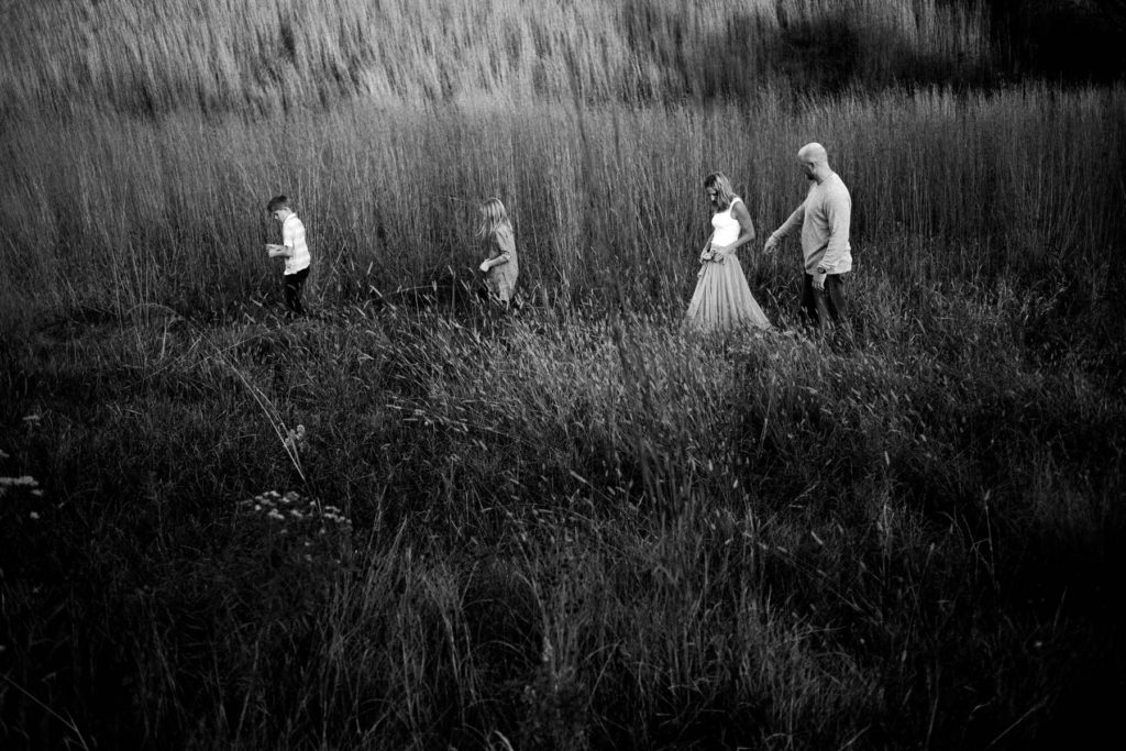 Hickory Creek Junction family session, Photos by Elle Baker Photography, New Lenox IL, family of four walking in field 