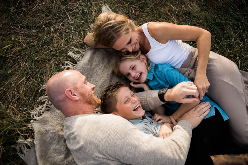 Hickory Creek Junction family session, Photos by Elle Baker Photography, New Lenox IL, family of four laying in field cuddling during session, posing ideas