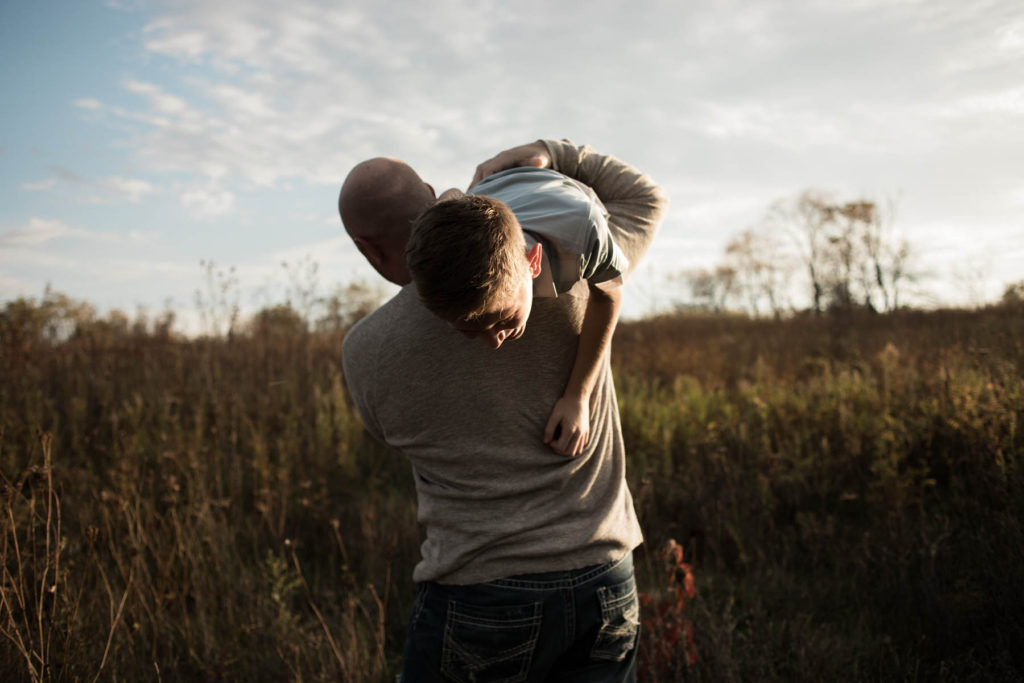 Hickory Creek Junction family session, Photos by Elle Baker Photography, New Lenox IL, dad carrying young boy in field 