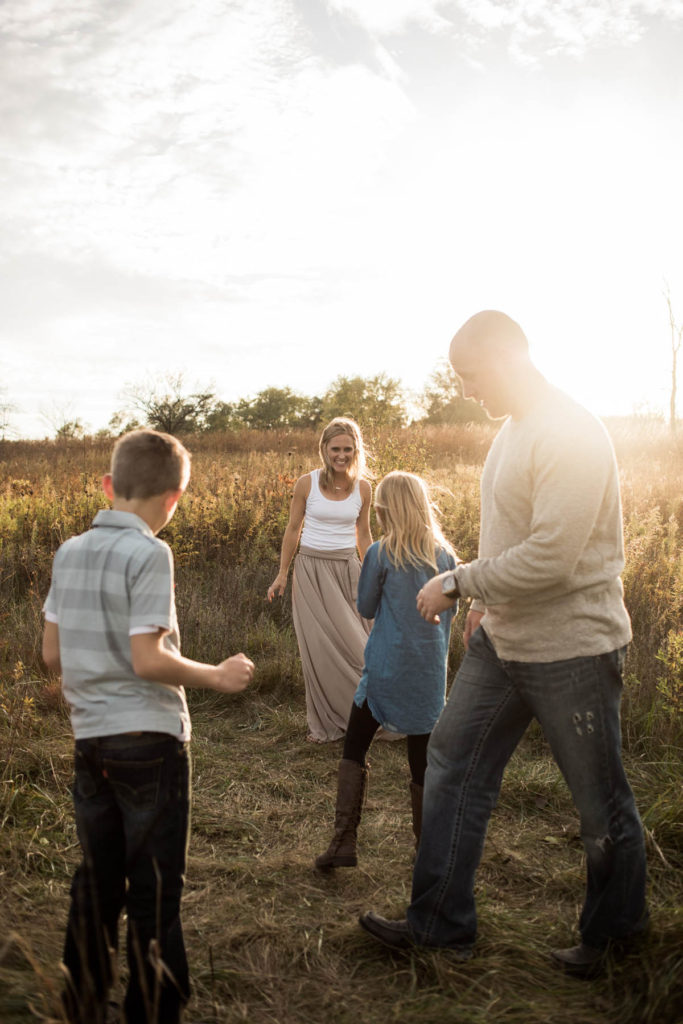 Hickory Creek Junction family session, Photos by Elle Baker Photography, New Lenox IL, family of four playing in field 
