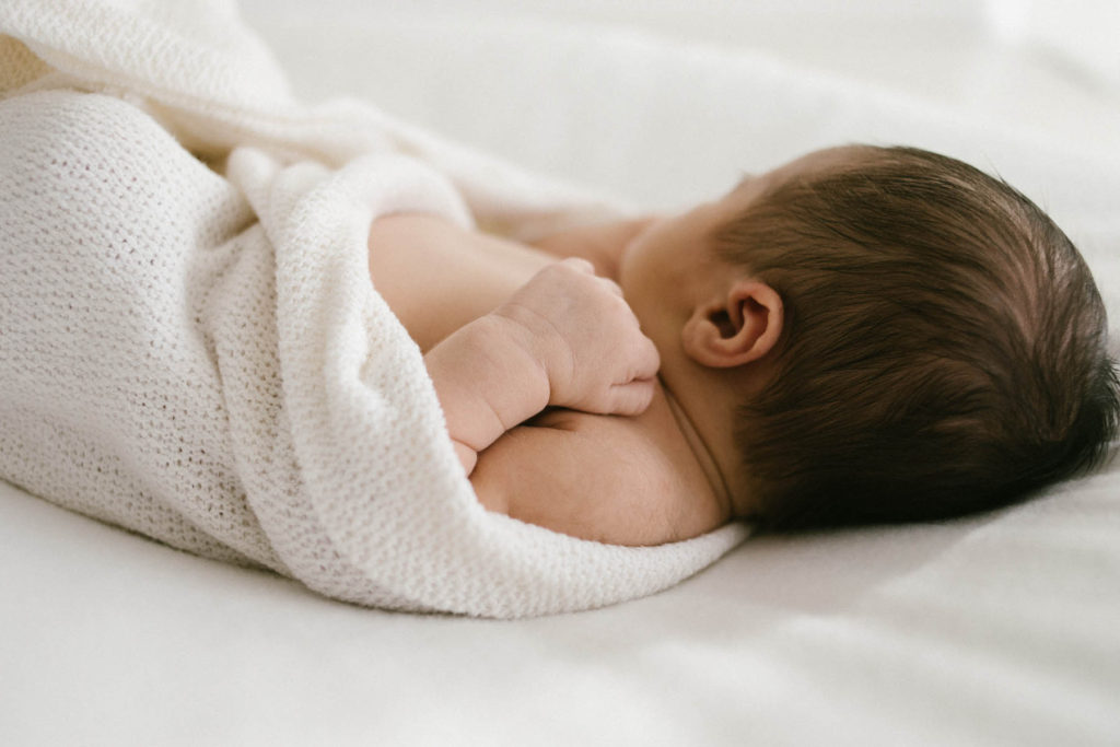 Homer Glen, IL newborn photography studio, Photo by Elle Baker Photography, newborn swaddled in white wrap in a white studio