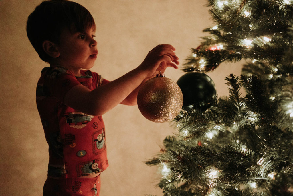 New Lenox, Illinois Family Photographer, Photo by Elle Baker Photography, lifestyle session with boy decorating Christmas tree