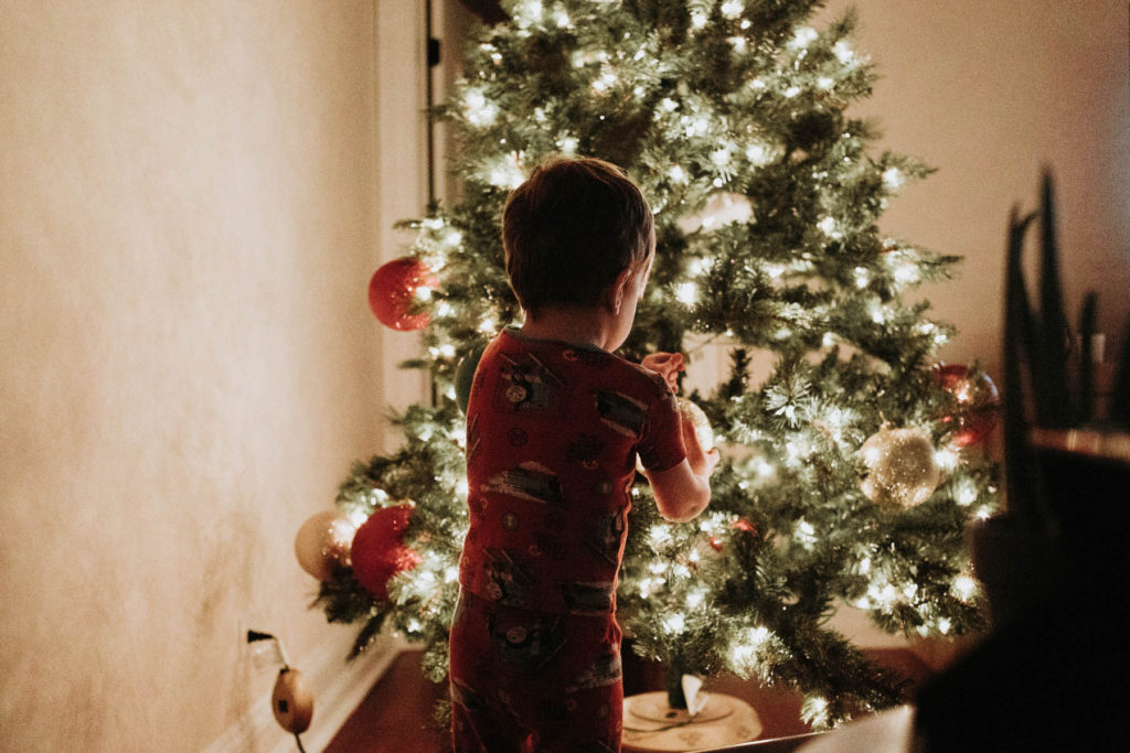 New Lenox, Illinois Family Photographer, Photo by Elle Baker Photography, lifestyle session with boy decorating Christmas tree