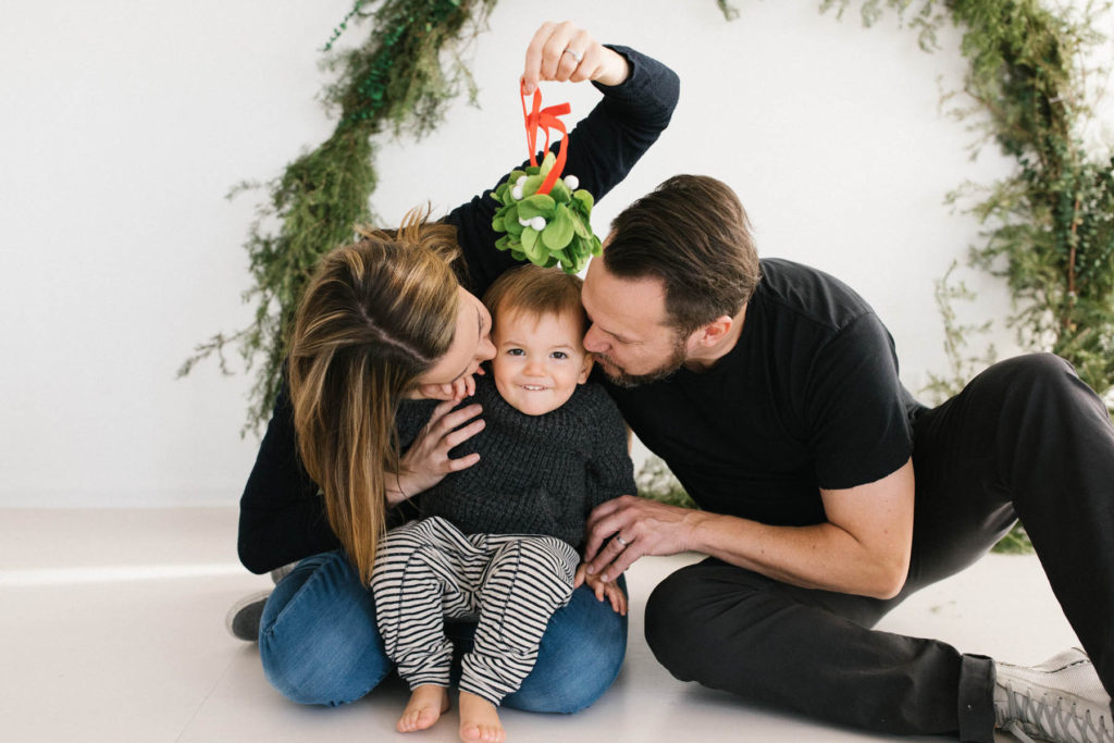 Homer Glen, IL Holiday Mini Sessions, Photo by Elle Baker Photography, family of three kissing during Christmas session Chicago