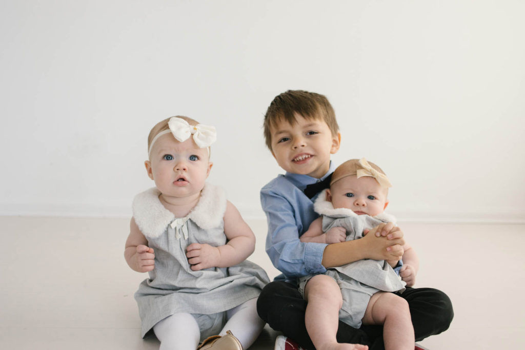 How to pose large families in small spaces, Frankfort IL family photographer, Elle Baker Photography, three children in white studio