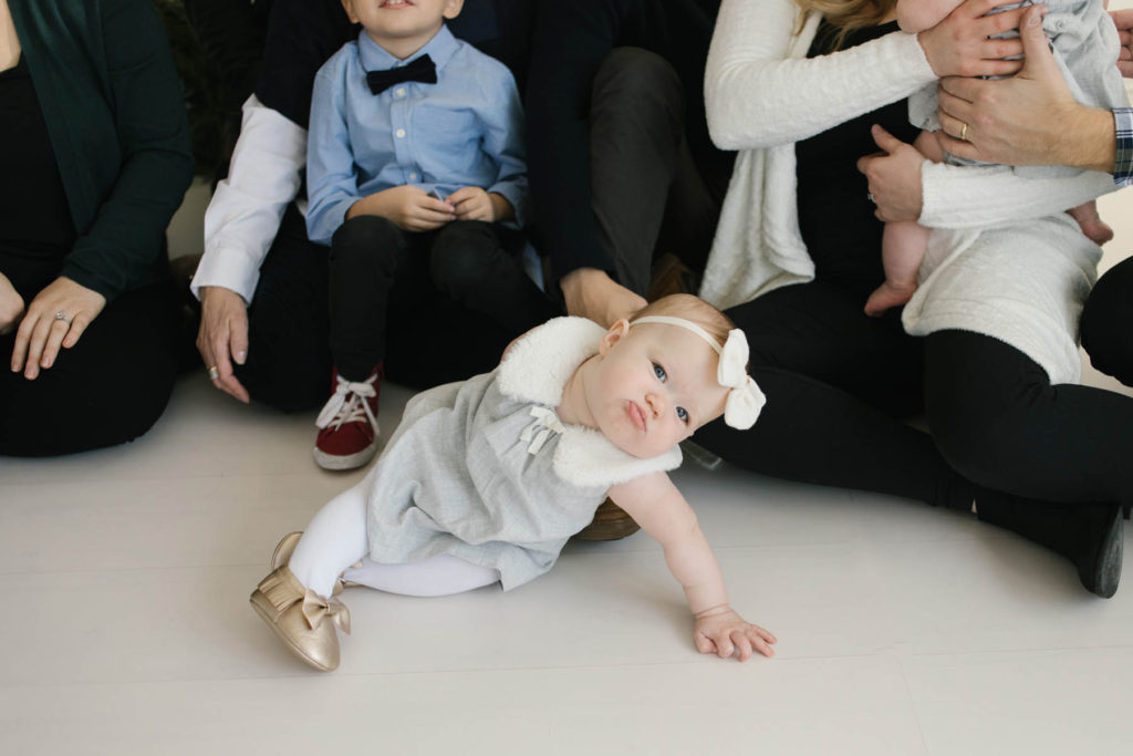 How to pose large families in small spaces, Frankfort IL family photographer, Elle Baker Photography, baby girl in white studio