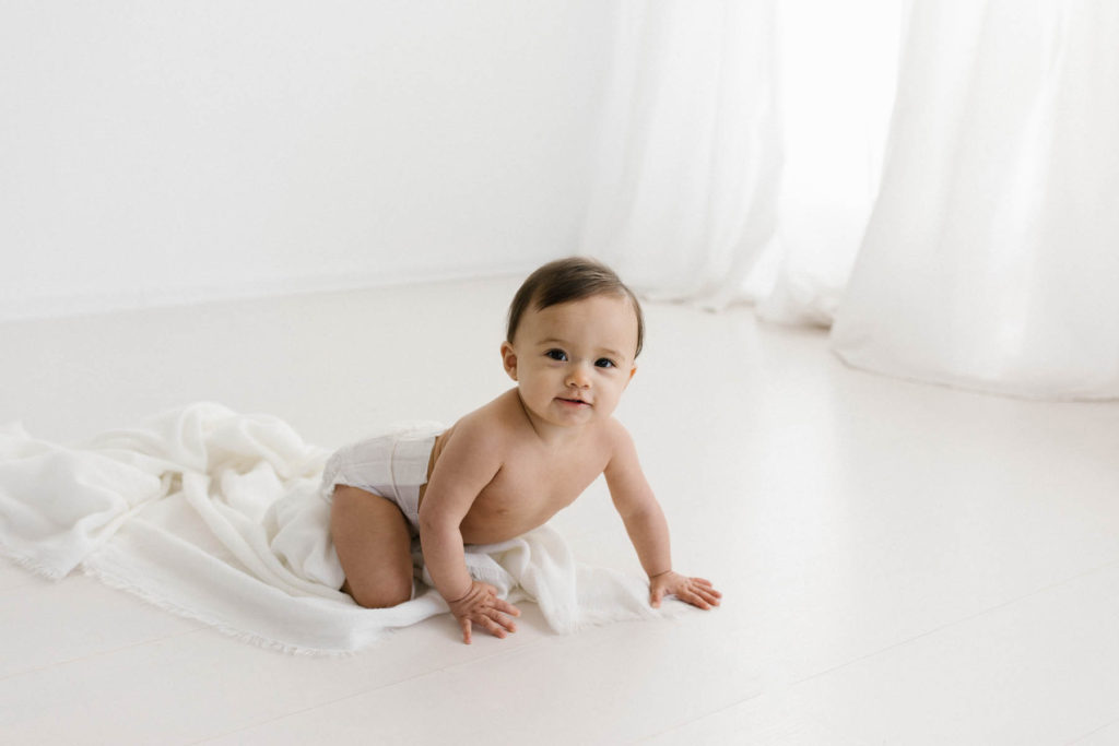 Simple and natural baby session, Photo by Elle Baker Photography, baby girl in white studio space in Chicago crawling