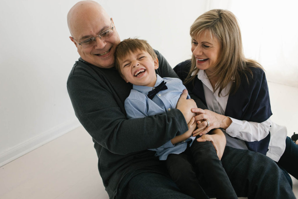 How to pose large families in small spaces, Frankfort IL family photographer, Elle Baker Photography, grandparents tickling young boy in studio