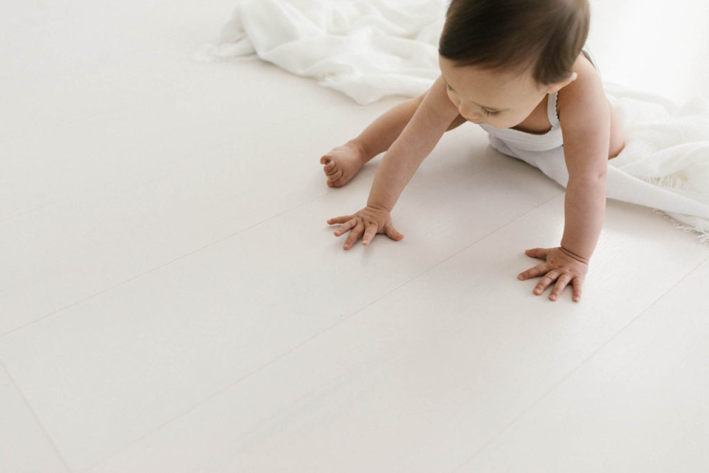 Simple and natural baby session, Photo by Elle Baker Photography, detail hand shot of baby girl in white studio space in Chicago