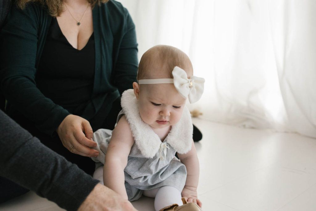 Christmas card photo ideas, Photo by Elle Baker Photography, baby girl and her parents at a holiday session