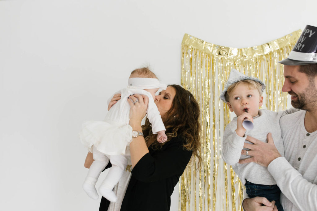 New Year's Photo Session, Photos by Elle Baker Photography, Mom kisses baby girl during studio session celebrating New Years