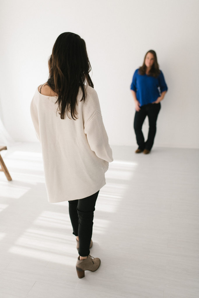 Laurie Baker is one of Chicago's Top Newborn Photographers at Elle Baker Photography. This image shows Laurie behind the scenes posing a woman for her headshots