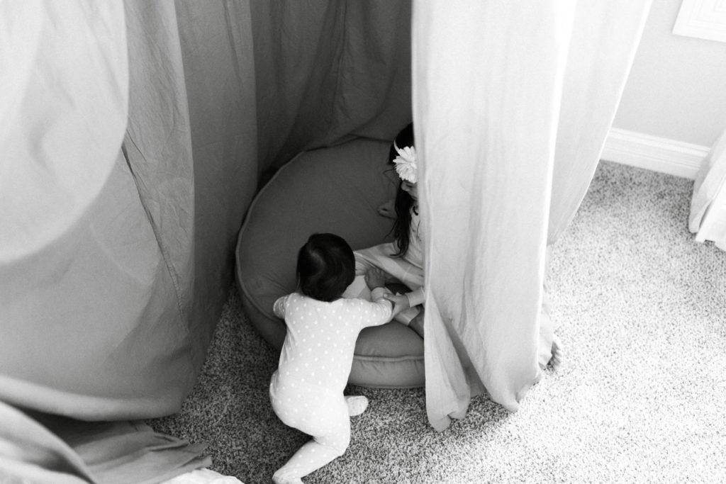 two little girls playing in a tent during lifestyle session 