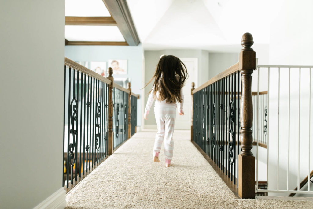 little girl running down the hall 
