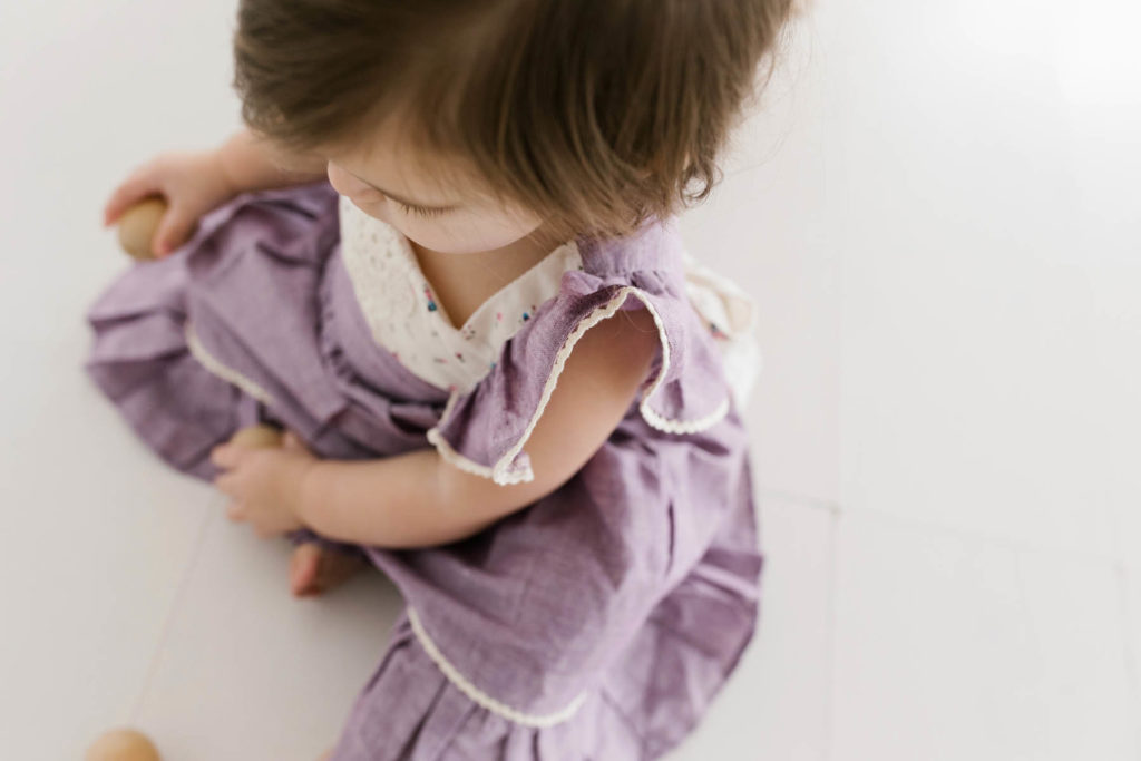 Adorable brunette toddler wearing a purple dress at Homer Glen studio 