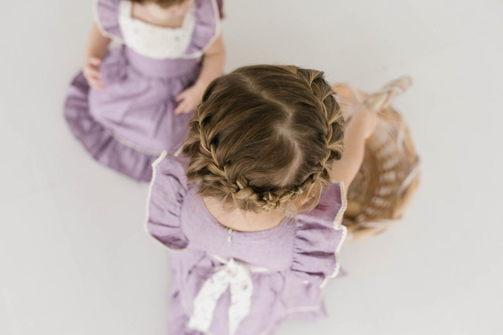 braided hair on a toddler girl wearing a lilac dress