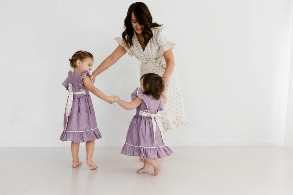 mom and daughter play candidly during fun photo shoot with Laurie Baker