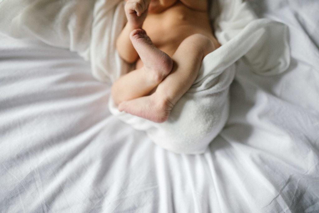 Downers Grove newborn photographer captures a newborns tiny feet during lifestyle session