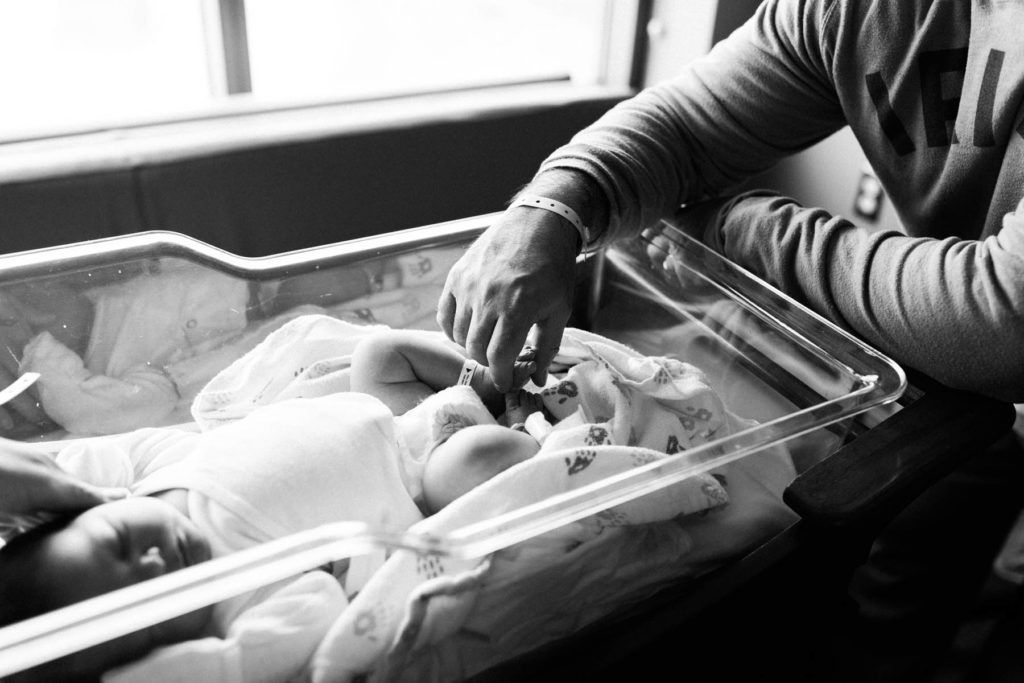 father touching baby's feet during Fresh 48 hospital session by Elle Baker Photography 
