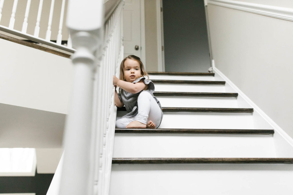 toddler girl climbs the stairs 