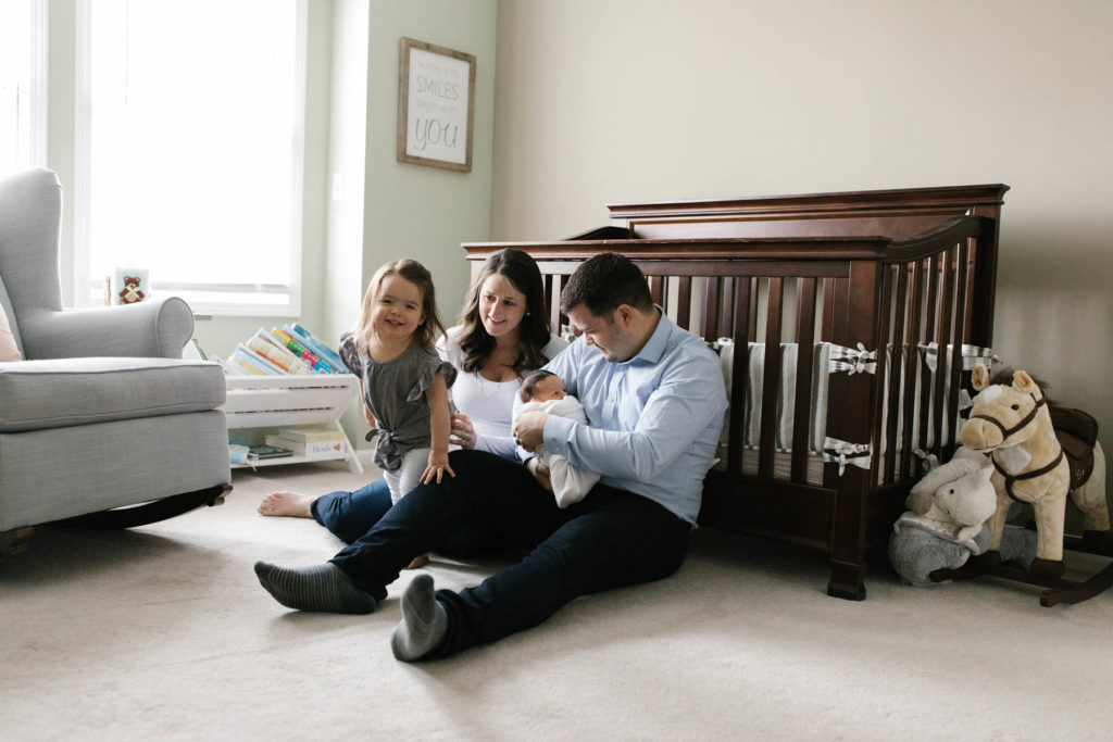 family of four in a nursery during lifestyle family session, photo by Elle Baker Photography 