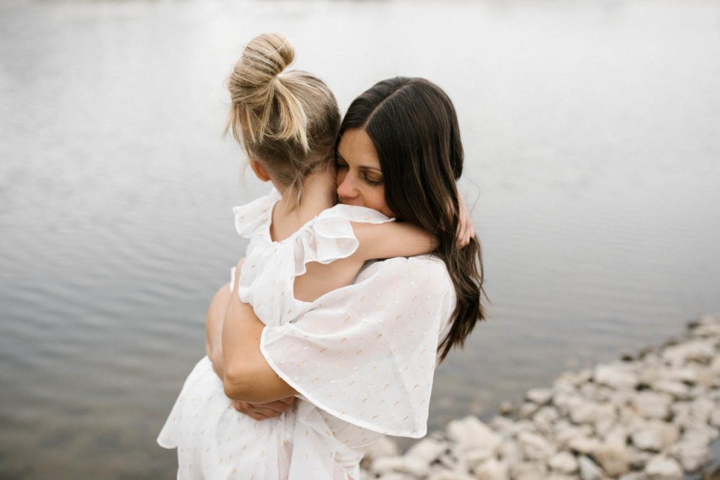 Mother hugging daughter during photo session with Elle Baker photography and wearing EleStory 