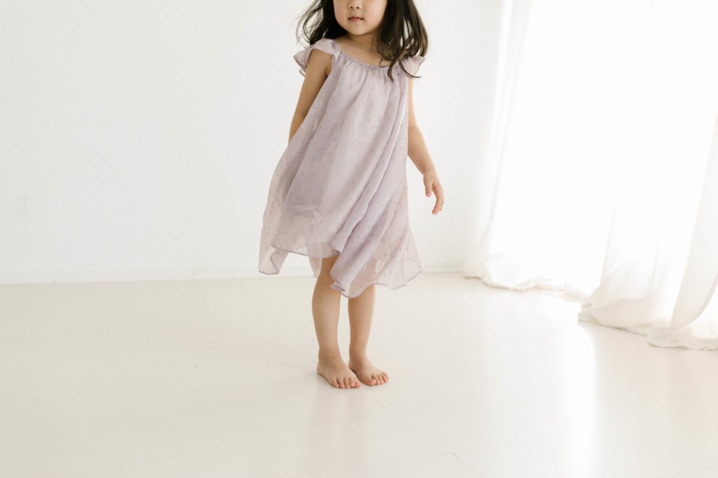 little girl modeling Ele Story's purple topaz dress captured by Chicago child photographer Laurie baker 
