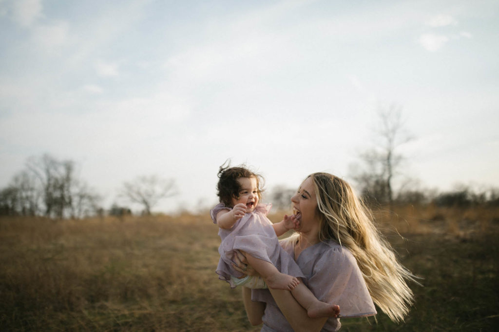mom holding her baby girl during photo session with Elle Baker Photography 