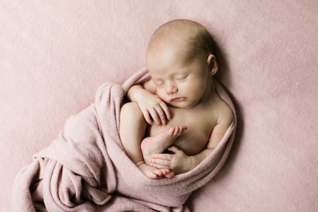newborn photographer Laurie Baker captures baby girl in pink blankets