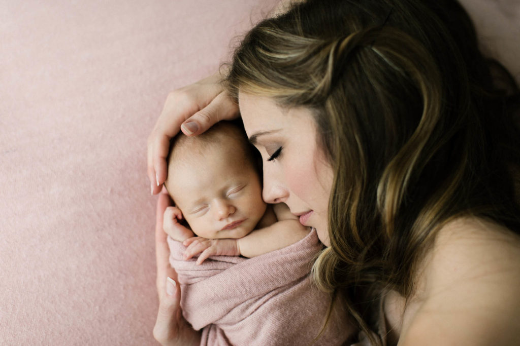 Mom and baby girl during newborn photo session with Elle Baker Photography 