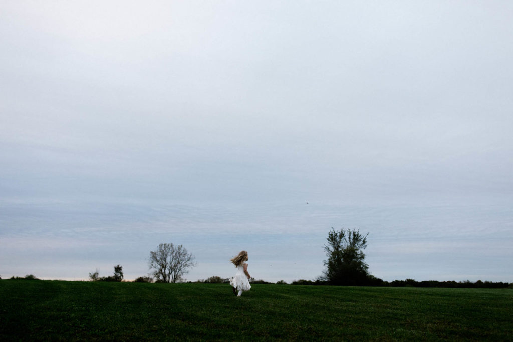 Chicago family and lifestyle photographer Laurie Baker captures little girl in a field 