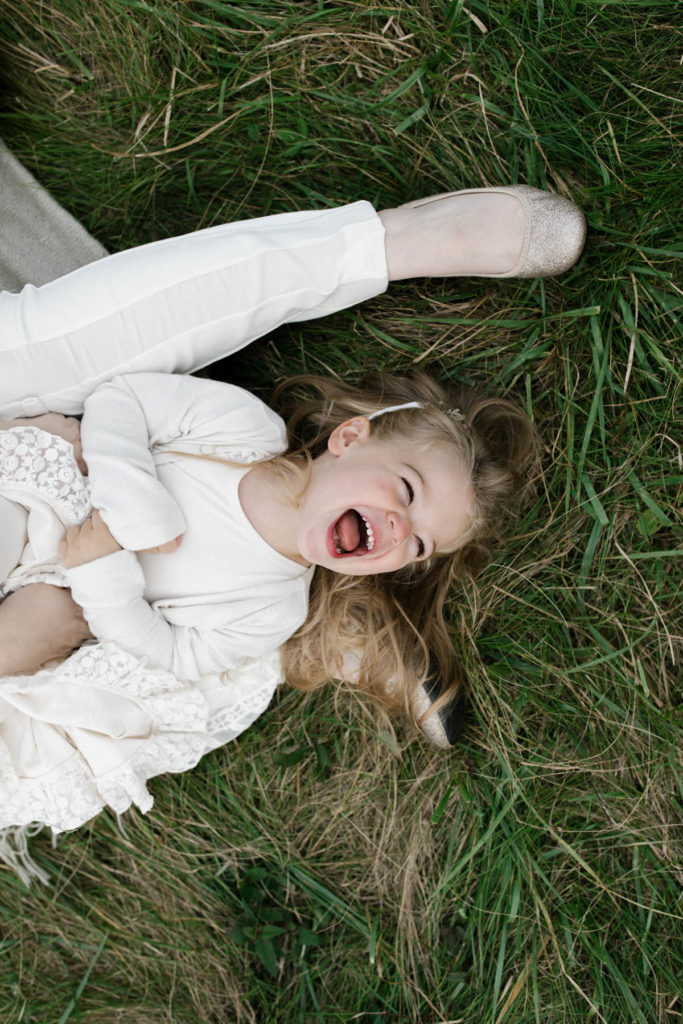 little girl laughs during sunset lifestyle session