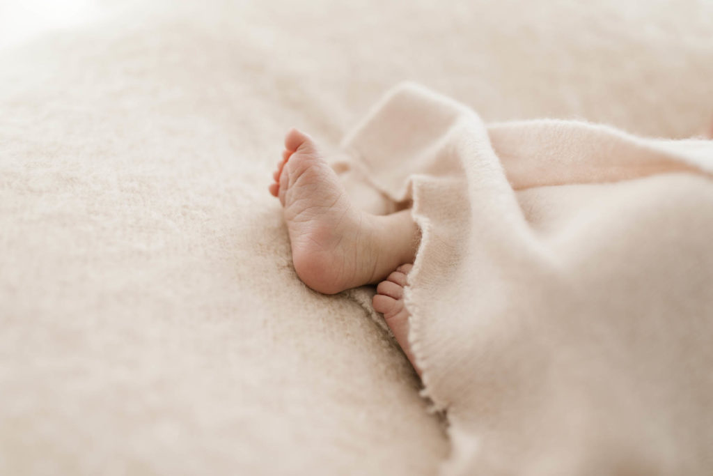 detail photo of a baby's foot during newborn photography session 
