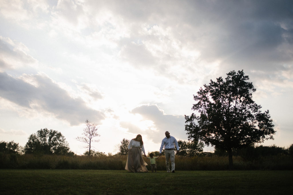 Illinois family lifestyle photographer Laurie Baker captures family walking into the sunset during family lifestyle session Elle Baker Photography 
