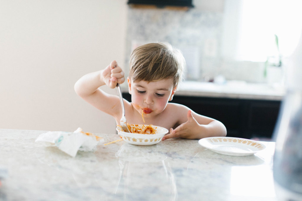 The art of the everyday lifestyle photography boy eating spaghetti dinner 