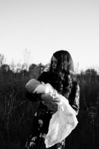 Gift Ideas for Photography Lovers New mother outdoors holding her newborn baby, New Lenox family photographer, Photos by Elle Baker Photography